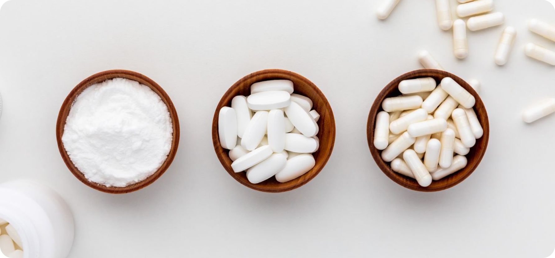 Three types of pills and capsules displayed together, highlighting their diverse forms and colors for health applications.